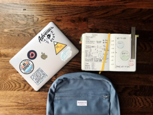 Image of a laptop, backpack, and notebook indicating that higher Education SEO is doesn't have to feel like homework.